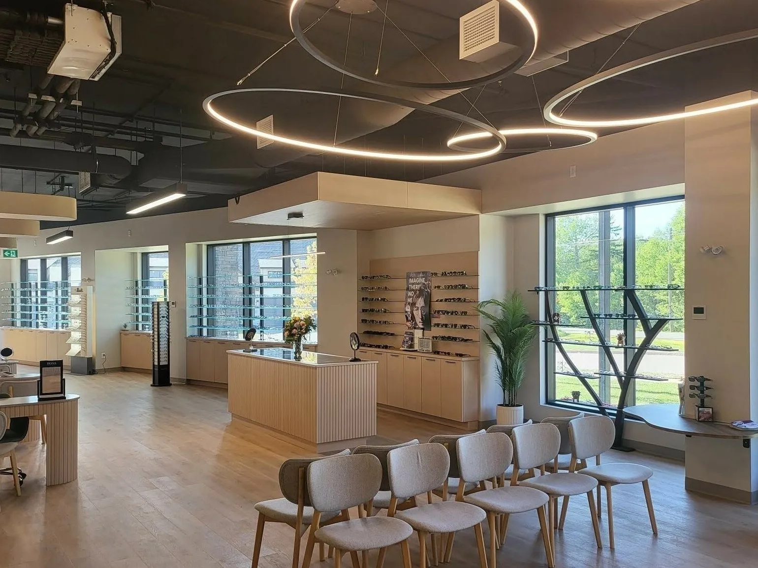 A finished retail interior with light oak fittings, ring lights and a waiting area